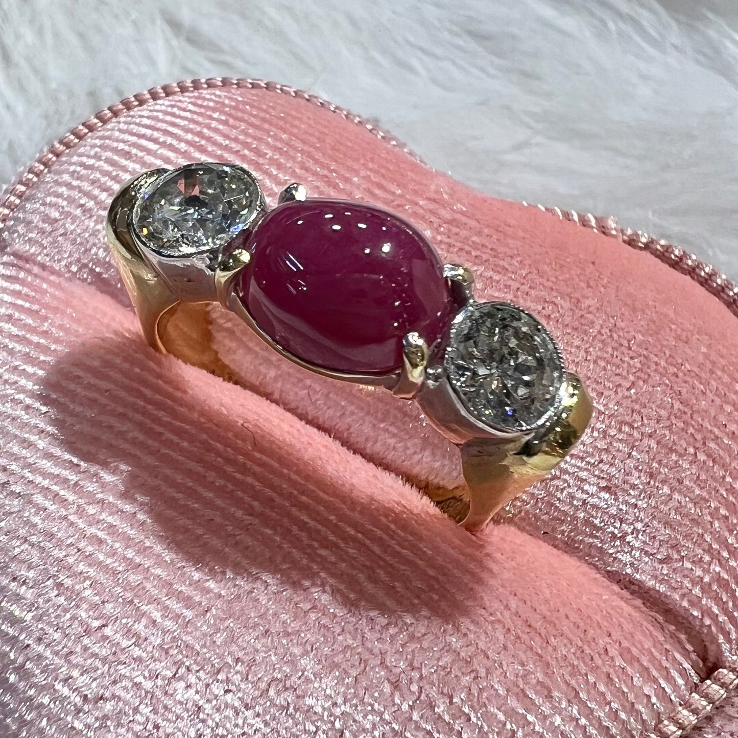 Ring with two diamonds and central cabochon ruby