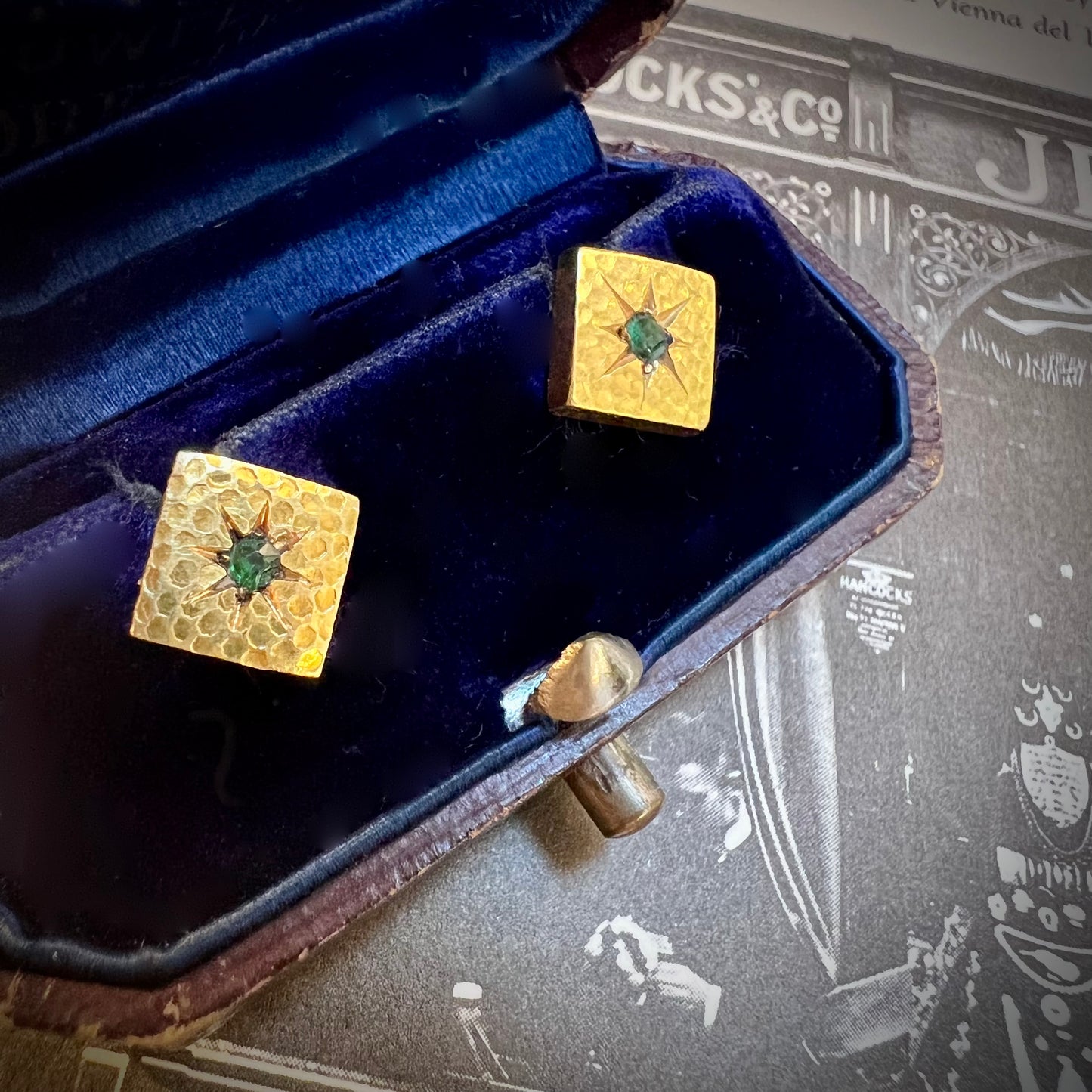 Pair of gold and emerald firing buttons