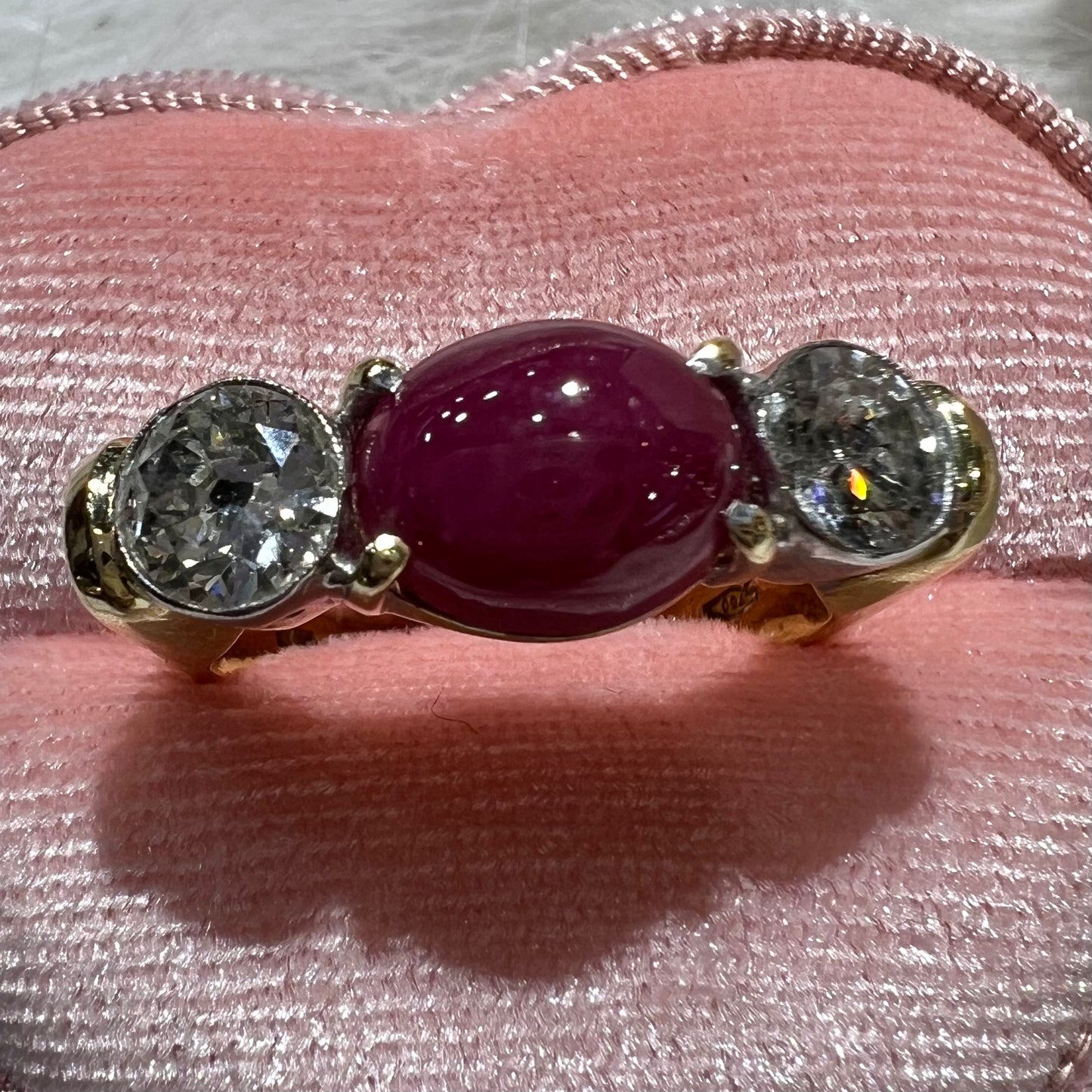 Ring with two diamonds and central cabochon ruby
