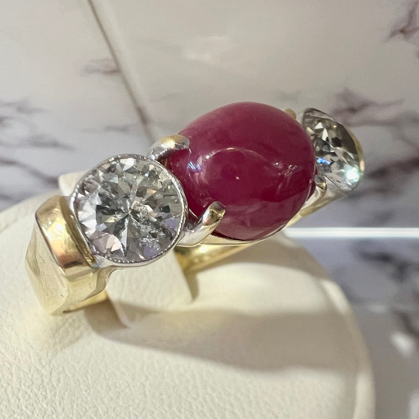 Ring with two diamonds and central cabochon ruby