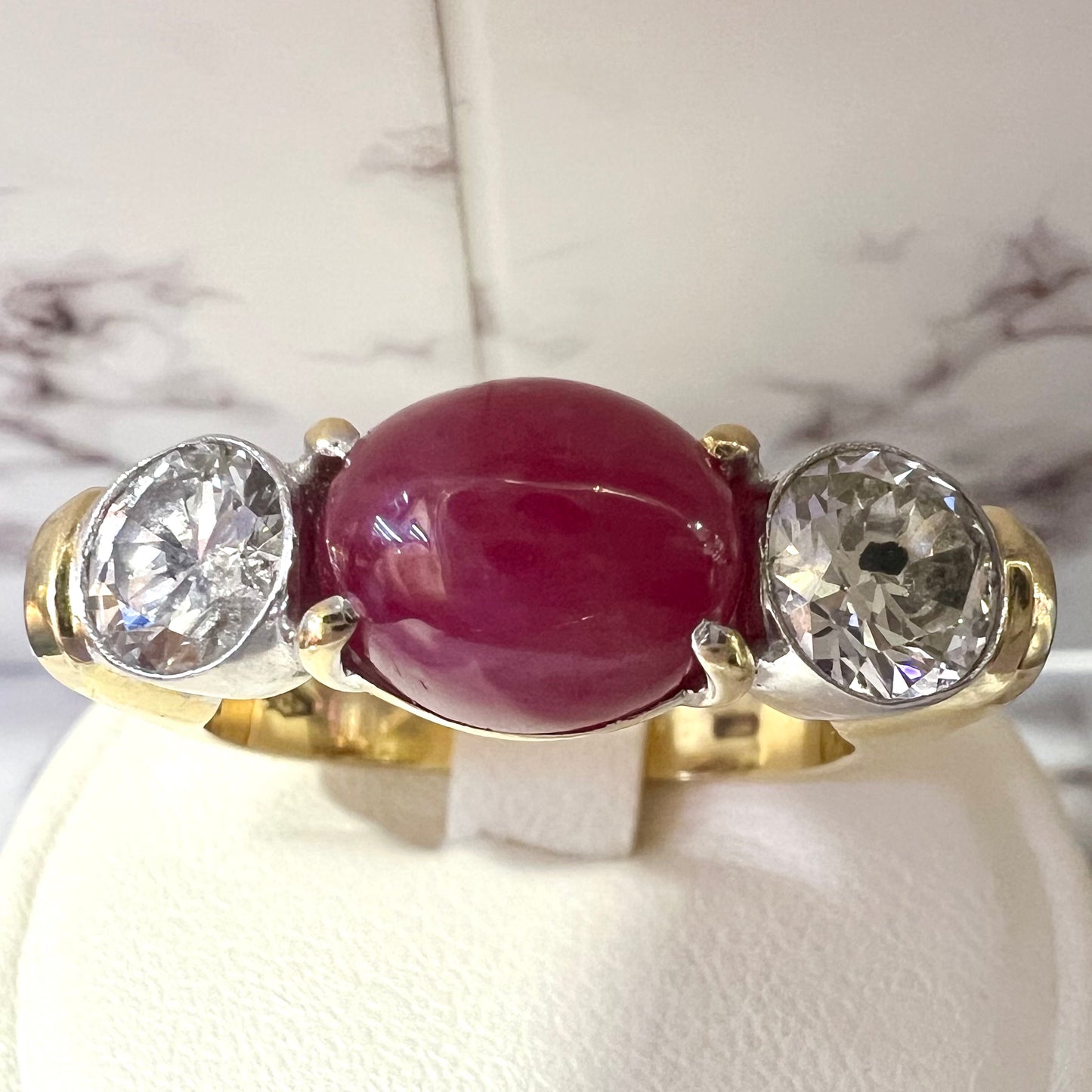Ring with two diamonds and central cabochon ruby