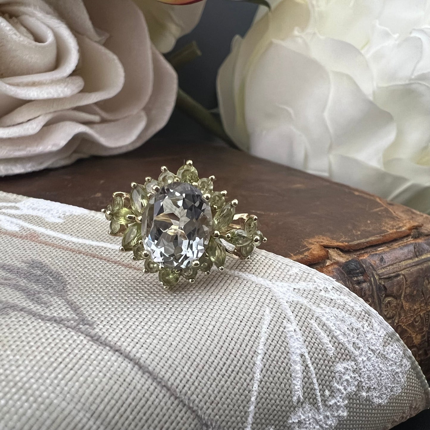 Anello con acquamarina centrale e fogliette di olivina in oro giallo