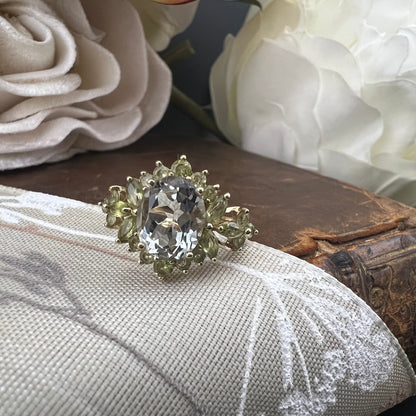 Anello con acquamarina centrale e fogliette di olivina in oro giallo