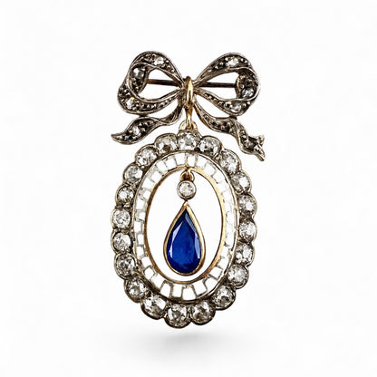 Deliziosa spilla Belle Époque in oro con fiocco, diamanti old mine e zaffiro pendente