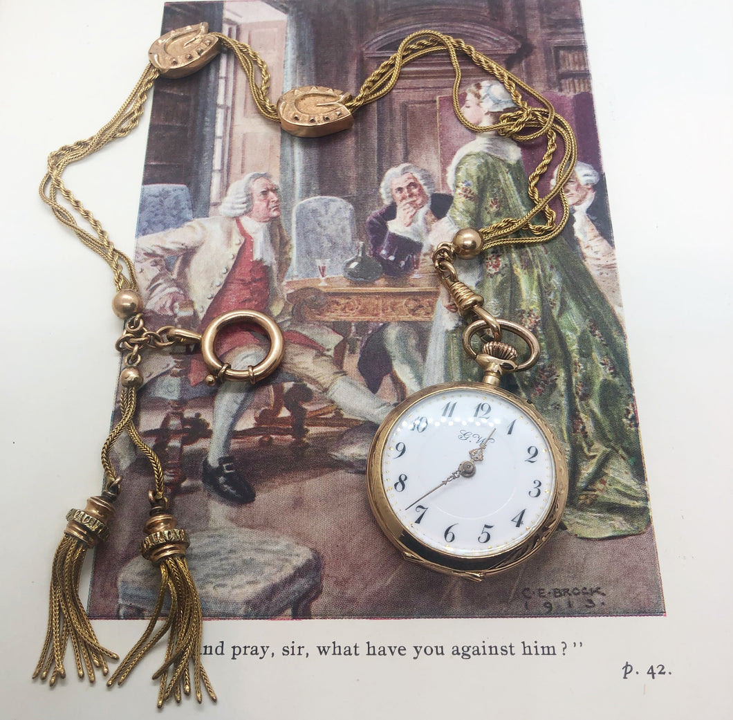 Orologio da tasca in oro Gander Watch con catena a tre fili e saliscendi a ferro di cavallo. Oro 18 carati. Svizzera primi del ‘900
